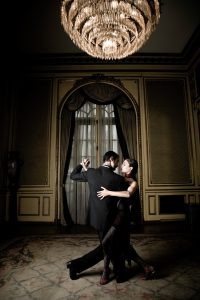 Young Couple Dancing Tango in Elegant Room